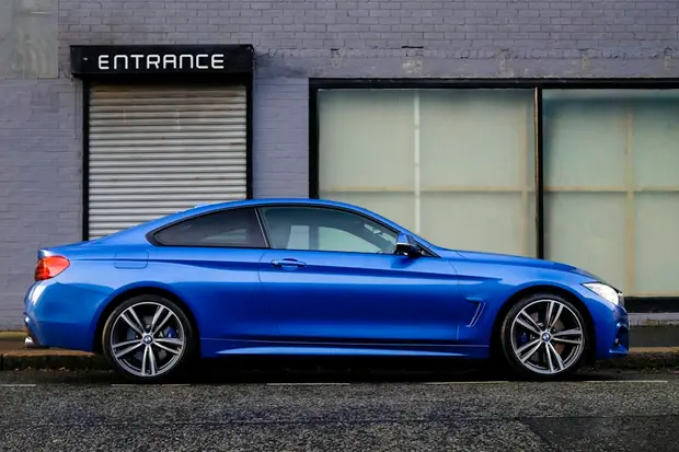 A blue BMW saloon, seen from the side