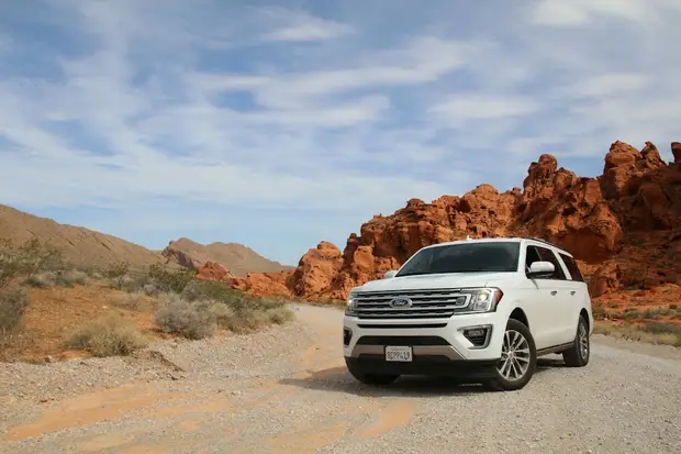 A white Volkswagen Tiguan on an open road
